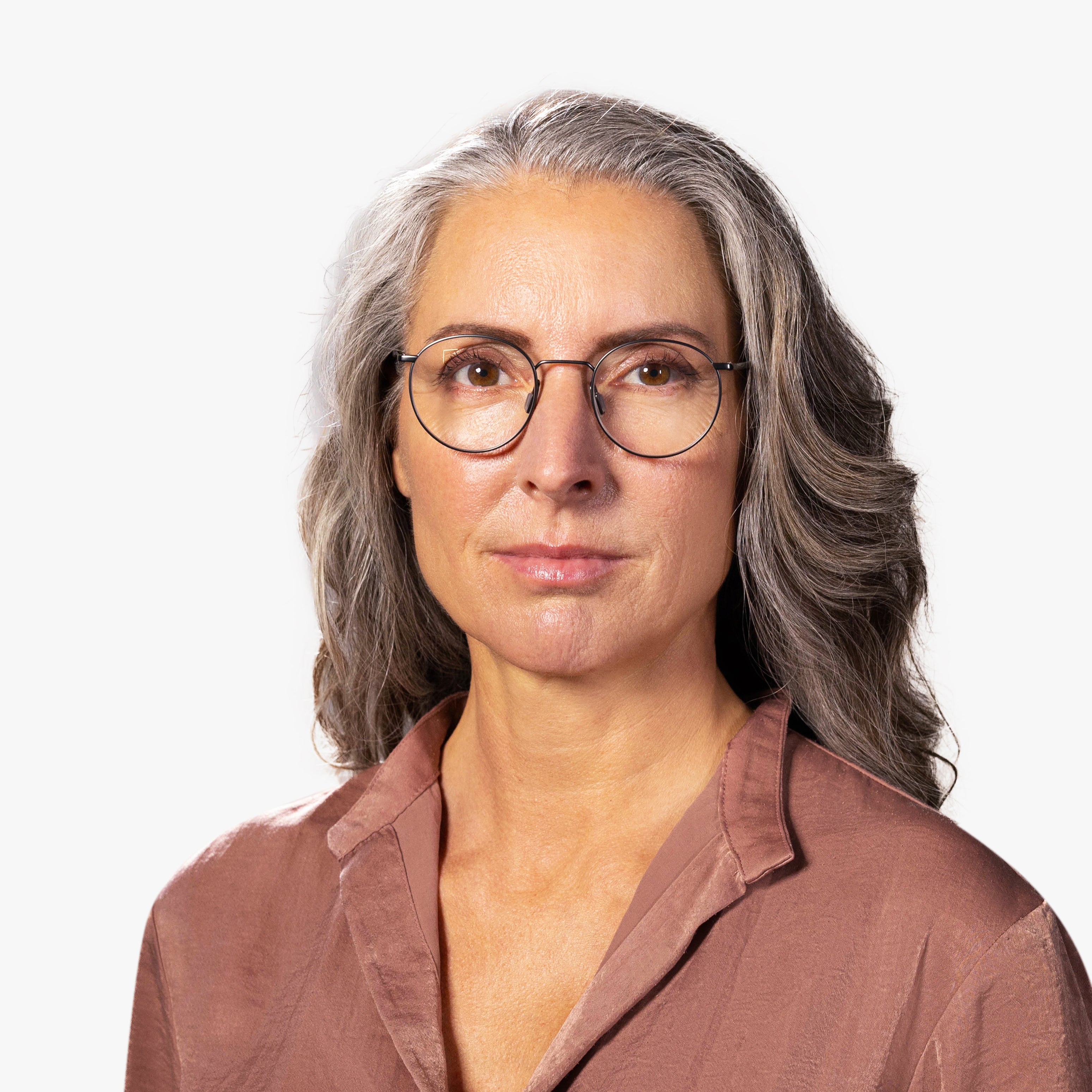 Person wearing round metal reading glasses